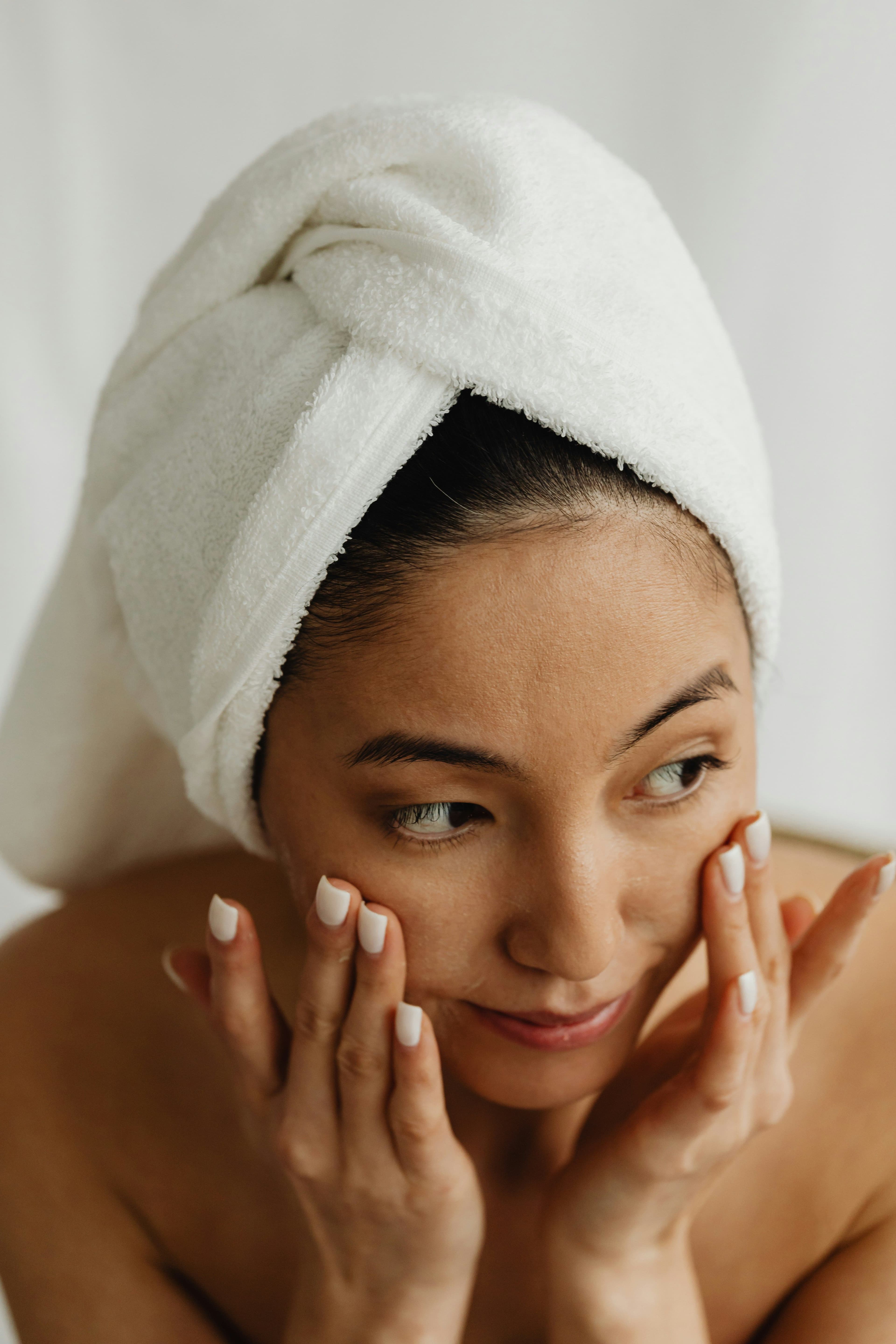 A woman applying skincare